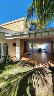 a house with a patio and a palm tree at Casa Tropical Kaylani in Tamanique