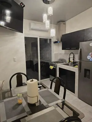 a kitchen with a table with chairs and a refrigerator at Luxury Living apartment P5314 in San Miguel