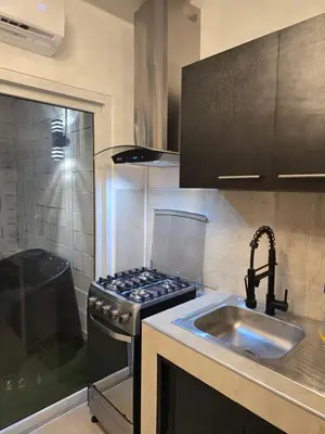 a kitchen with a stove top oven next to a sink at Luxury Living apartment P1620 in San Miguel