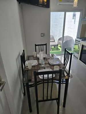 a dining room table with four chairs and a table and chairsktop at Luxury Living apartment P1620 in San Miguel