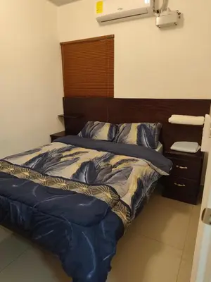 a bed with a blue comforter in a bedroom at Luxury Living apartment P1620 in San Miguel