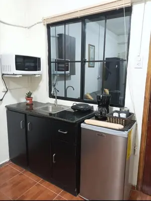 a kitchen with a sink and a dishwasher at Cuarto estudio HERSOR in San Salvador