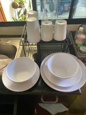 a group of white plates sitting on a shelf at Cuarto estudio HERSOR in San Salvador