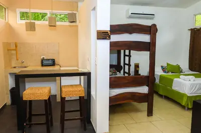 a room with a desk and a bunk bed at Eco del Mar in La Libertad