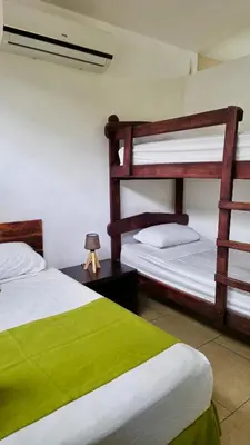 a bedroom with two bunk beds and a lamp at Eco del Mar in La Libertad