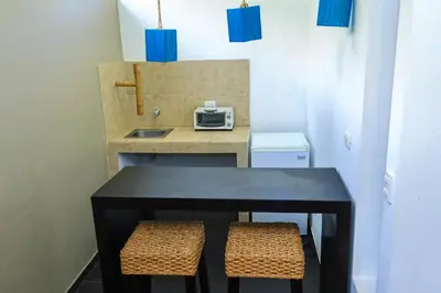 a small kitchen with a black table and two stools at Eco del Mar in La Libertad