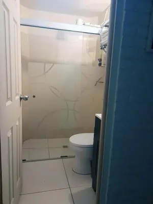 a bathroom with a shower and a toilet in it at La Cima House-Studio in San Salvador