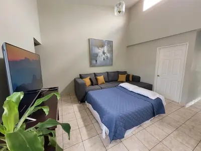 a bedroom with a bed and a couch at Familiar cómodo centrico in San Salvador