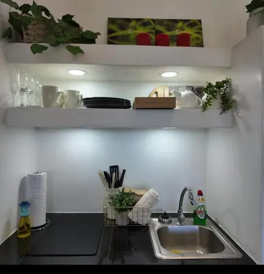 a kitchen counter top with a sink and a counter top at Las Terrazas Suites Studio Apartment in San Salvador