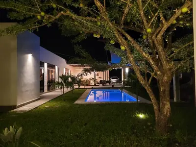 a swimming pool in the yard of a house at night at Residence in Salinitas, Los Cobanos in Los Cóbanos
