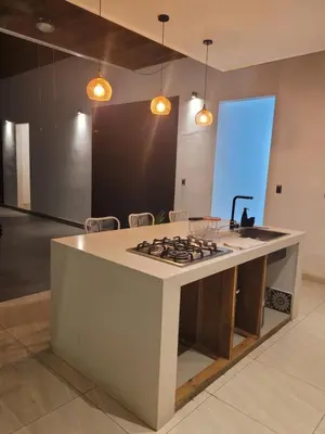 a kitchen with a stove top island in a room at Residence in Salinitas, Los Cobanos in Los Cóbanos