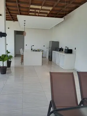 a large room with chairs and a counter with a kitchen at Residence in Salinitas, Los Cobanos in Los Cóbanos