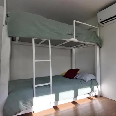 a bedroom with a bunk bed with a ladder at Las Terrazas Suites Studio-type apartment in San Salvador