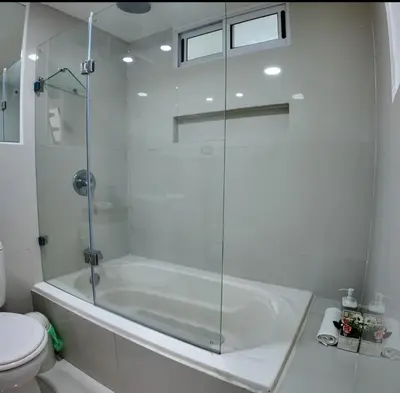 a white bathroom with a tub and a toilet at Las Terrazas Suites Studio-type apartment in San Salvador
