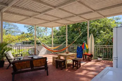 a patio with a hammock and a table and chairs at Zonte Rooftide Studio in ChiltiupÃ¡n
