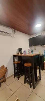 a wooden table with stools in a room at Zonte Rooftide Studio in ChiltiupÃ¡n