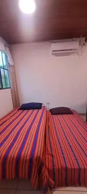 a bedroom with two beds with a striped blanket at Zonte Rooftide Studio in ChiltiupÃ¡n
