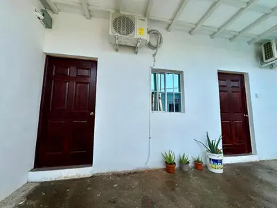 two doors of a building with potted plants in front at Tu Estancia en Sonsonate in Sonsonate