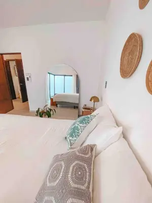 a bedroom with a white bed and a mirror at Villa Uma 50m to Zonte wave 2Bdr in El Zonte