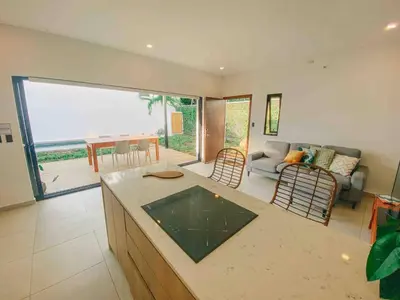 a kitchen and living room with a view of the ocean at Villa Uma 50m to Zonte wave 2Bdr in El Zonte