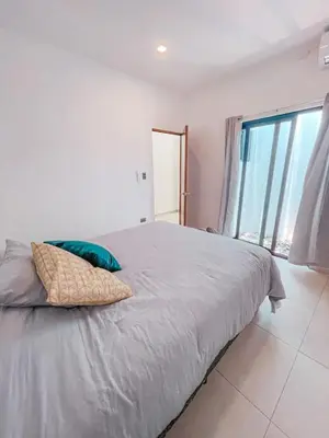 a bedroom with a large bed with a large window at Villa Uma 50m to Zonte wave 2Bdr in El Zonte