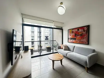 a living room with a couch and a table at Apartamento amueblado Condado Santa Rosa Santa Tecla La Libertad in Nanastepeque