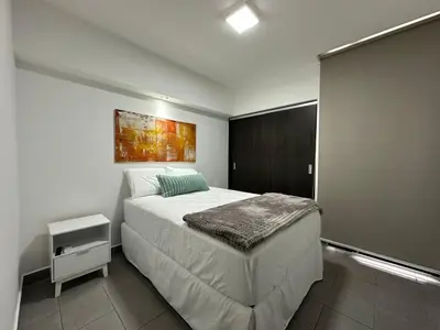 a bedroom with a bed and a painting on the wall at Apartamento amueblado Condado Santa Rosa Santa Tecla La Libertad in Nanastepeque