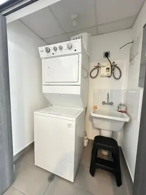 a small white kitchen with a sink and a stove at Apartamento amueblado Condado Santa Rosa Santa Tecla La Libertad in Nanastepeque