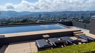 a swimming pool on the roof of a building at Exclusive Apartment with Pool & Rooftop in El Salvador in San Salvador
