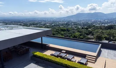 a swimming pool on the roof of a house at Exclusive Apartment with Pool & Rooftop in El Salvador in San Salvador