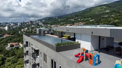 a building with a swimming pool on top of it at Exclusive Apartment with Pool & Rooftop in El Salvador in San Salvador