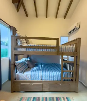 two bunk beds in a room with a window at Bungalow en La Playa- Amatecampo Villas in La Esmeralda