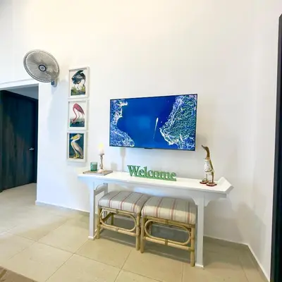 a white desk with a tv on a wall at Bungalow en La Playa- Amatecampo Villas in La Esmeralda
