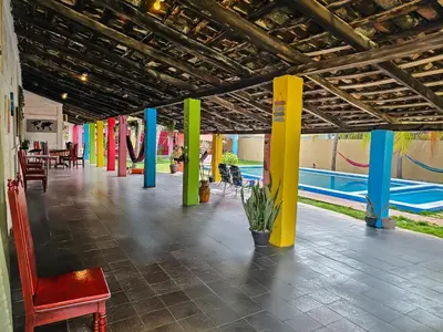 a hallway with colorful columns and a playground at Rancho Samba do Sol in Acajutla