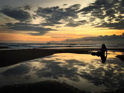 a person walking on the beach with a surfboard at Rancho Samba do Sol in Acajutla