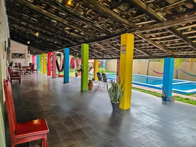 a hallway with colorful columns and a playground at Rancho Samba do Sol in Acajutla