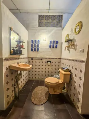 a bathroom with a toilet and a sink at Rancho Samba do Sol in Acajutla