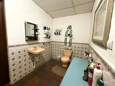 a bathroom with a toilet and a sink at Rancho Samba do Sol in Acajutla