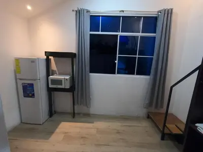 a room with a refrigerator and a window at Mini casa de árbol, mágica, céntrica y de vistas panorámicas in San Salvador