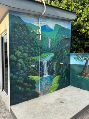 a mural on the side of a building with a waterfall at Container house in La Esmeralda