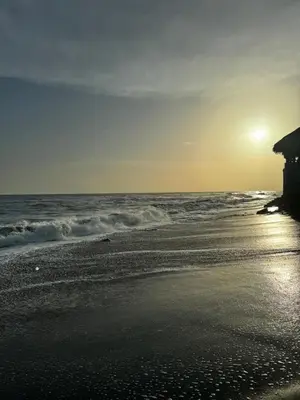 a sunset on a beach with the ocean at Container house in La Esmeralda