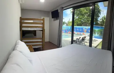 a bedroom with a bed and a view of a pool at Container house in La Esmeralda