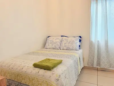 a small bedroom with a bed with a green towel on it at House for entire families in a private area in San Miguel