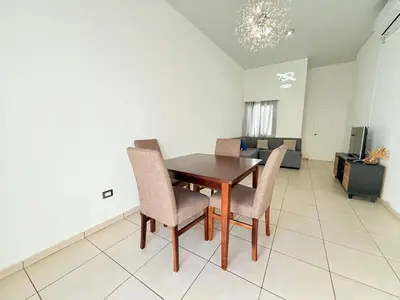 a dining room table and chairs in a living room at House for entire families in a private area in San Miguel