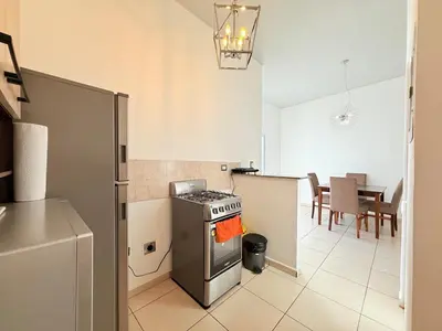 a kitchen with a stove and a dining room at House for entire families in a private area in San Miguel