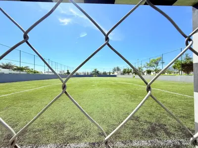 a soccer field seen through a chain link fence at House for entire families in a private area in San Miguel