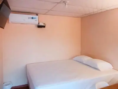 a small room with a white bed in it at Casa Independencia de Santa Ana in Santa Ana