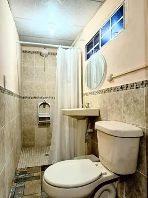 a bathroom with a toilet and a sink and a shower at Casa Independencia de Santa Ana in Santa Ana