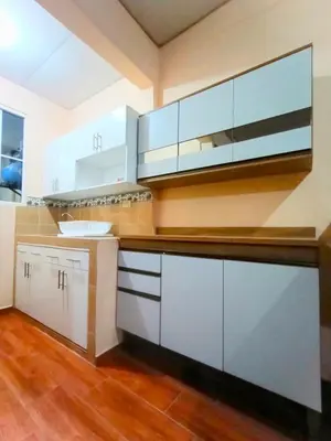 a kitchen with white cabinets and wood floors at Casa Independencia de Santa Ana in Santa Ana
