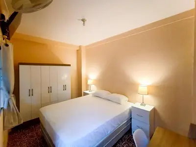 a bedroom with a white bed with two pillows on it at Casa Independencia de Santa Ana in Santa Ana